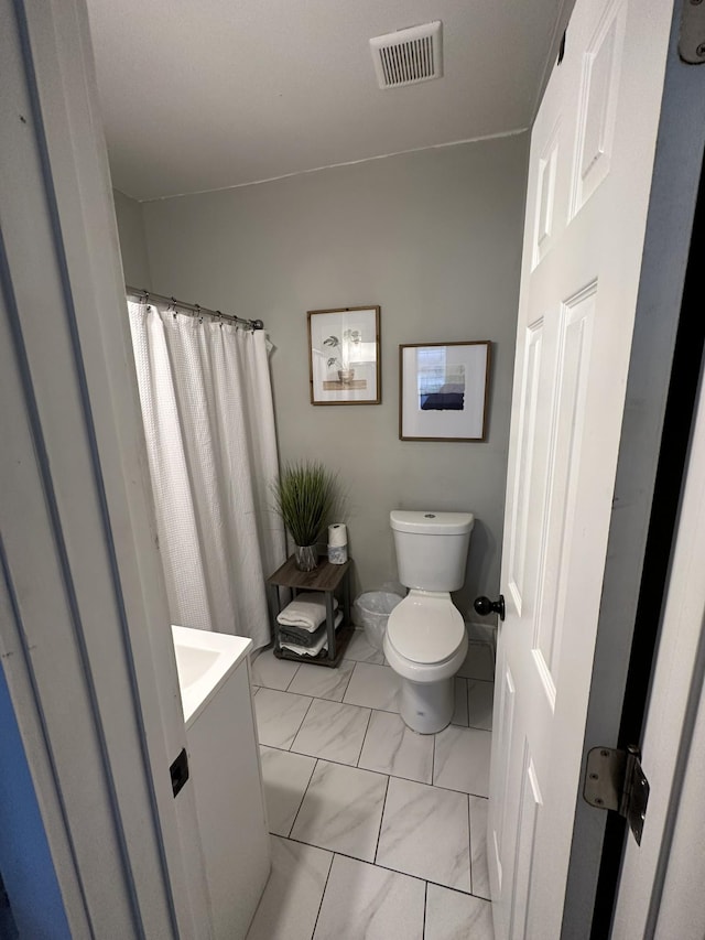 bathroom featuring vanity and toilet