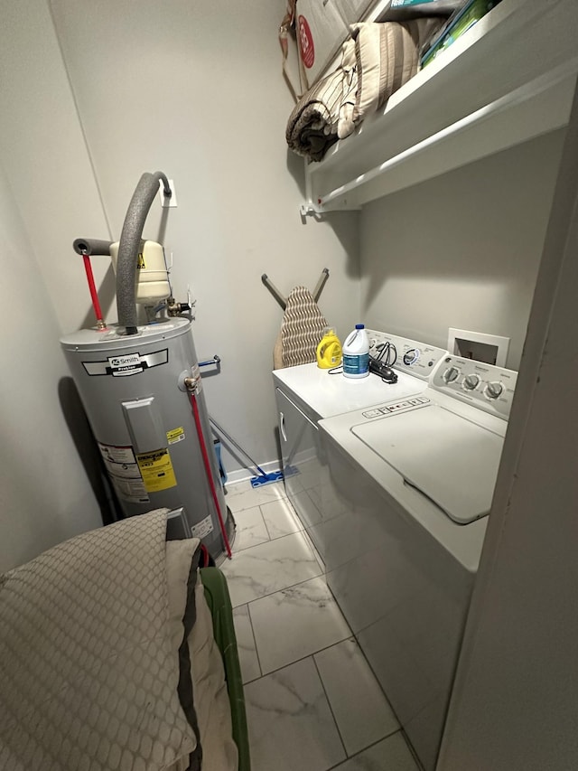 laundry area with electric water heater and washer and dryer