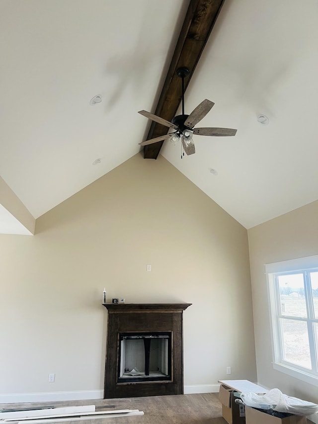 interior details featuring ceiling fan, beam ceiling, and carpet