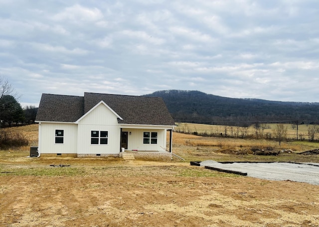 view of front of property featuring a mountain view and a rural view