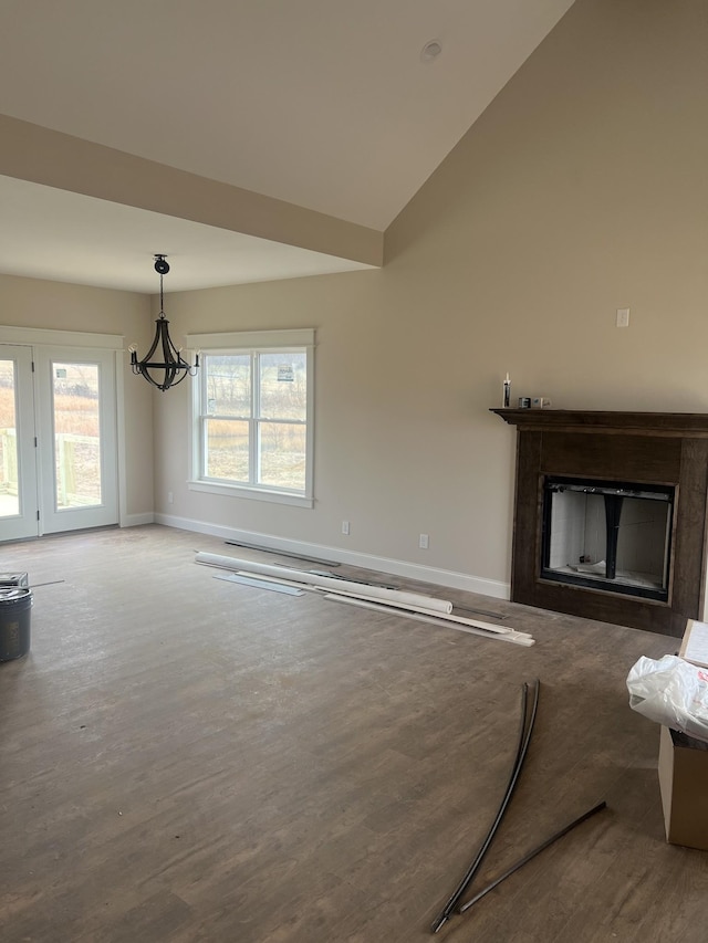 living room featuring an inviting chandelier, hardwood / wood-style flooring, and a healthy amount of sunlight