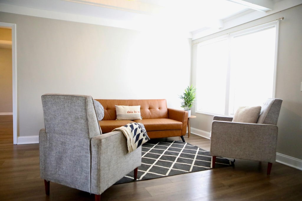 living room featuring hardwood / wood-style flooring and beamed ceiling