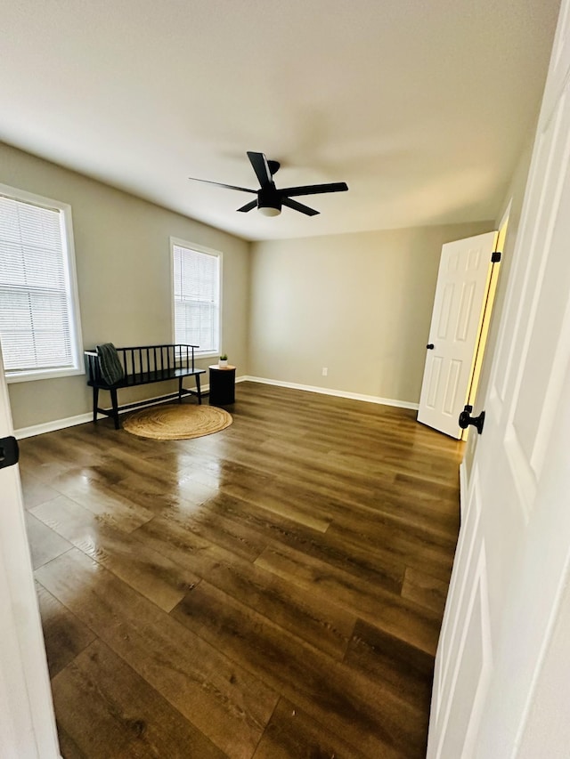 spare room with ceiling fan and dark hardwood / wood-style floors