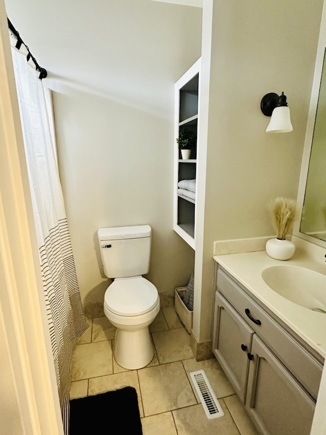 bathroom with tile patterned floors, toilet, and vanity