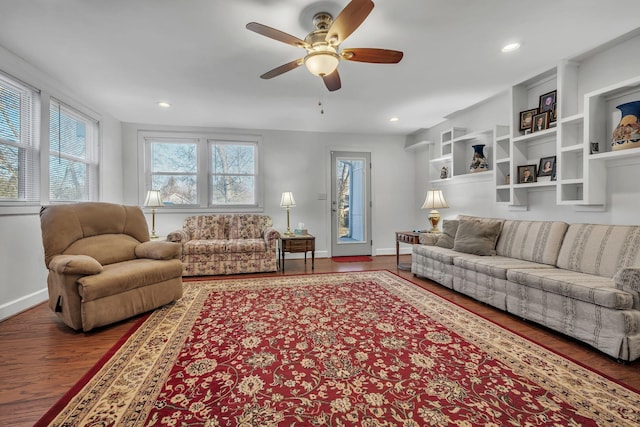 living room featuring hardwood / wood-style floors and ceiling fan