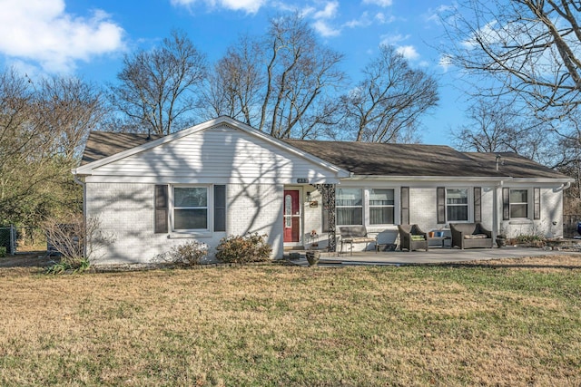 ranch-style house with an outdoor living space, a front lawn, and a patio area