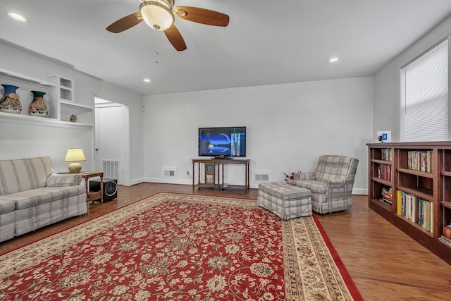 living room featuring hardwood / wood-style flooring and ceiling fan