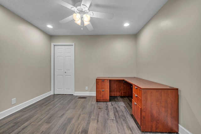 unfurnished office featuring ceiling fan and dark hardwood / wood-style floors