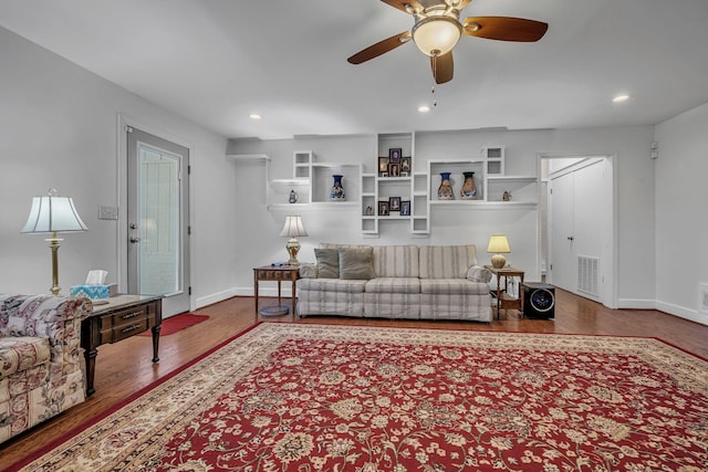 living room with ceiling fan and hardwood / wood-style floors