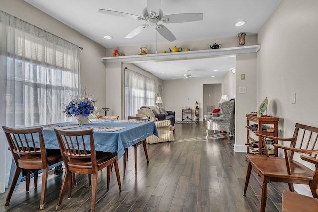 dining space with ceiling fan and dark hardwood / wood-style flooring