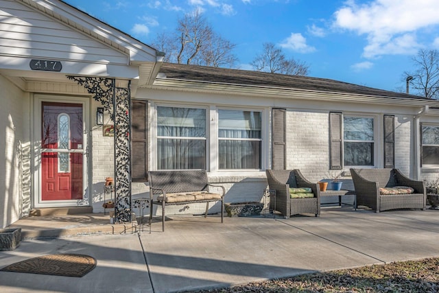 doorway to property featuring outdoor lounge area and a patio