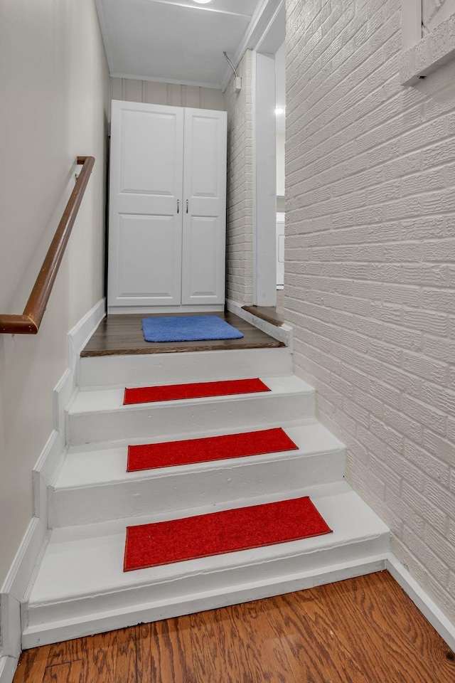 stairs featuring hardwood / wood-style flooring