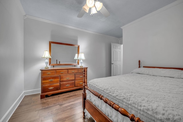 bedroom featuring crown molding, hardwood / wood-style floors, and ceiling fan