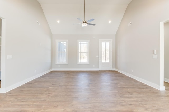 unfurnished living room with ceiling fan, high vaulted ceiling, and light hardwood / wood-style floors