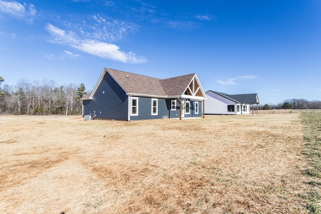 back of house with a lawn