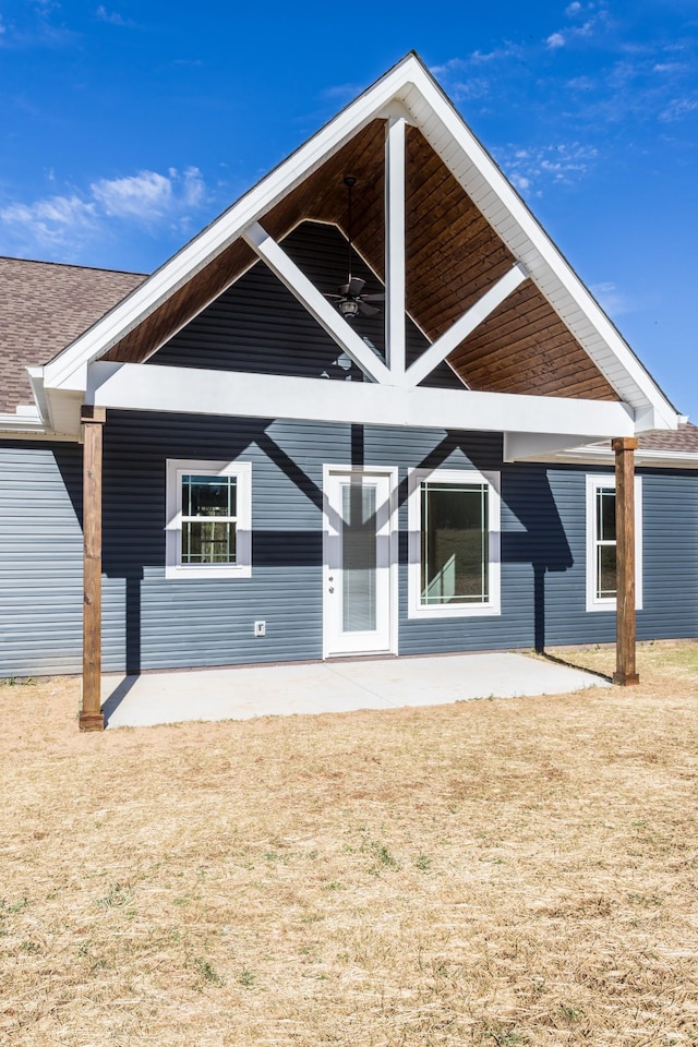 back of house featuring a lawn and a patio area