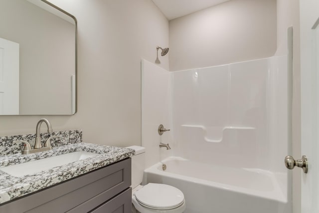 full bathroom featuring toilet, vanity, and  shower combination