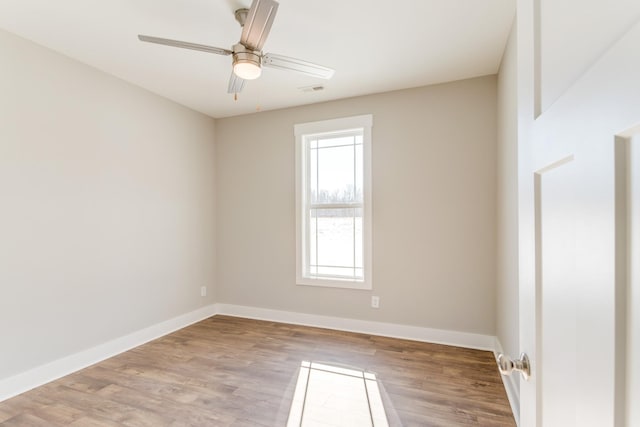 spare room with wood-type flooring and ceiling fan