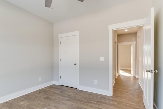 unfurnished bedroom with ceiling fan and light hardwood / wood-style flooring