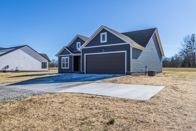 view of front of property with a garage and cooling unit