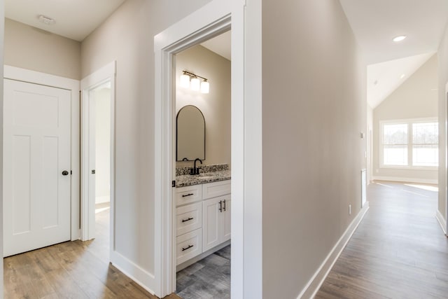 hall featuring sink and light hardwood / wood-style floors