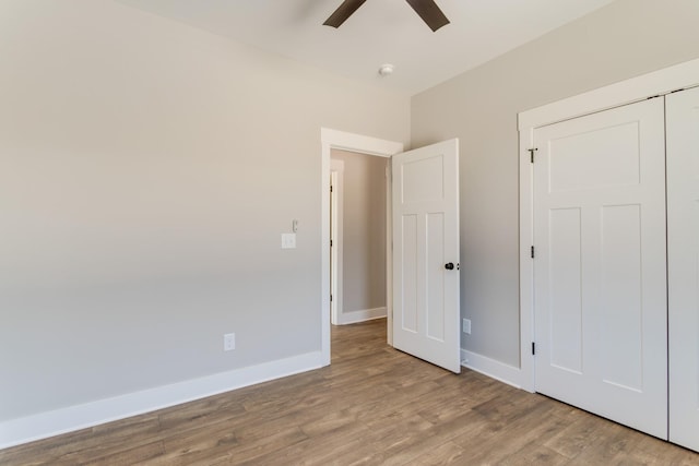 unfurnished bedroom with ceiling fan, light hardwood / wood-style floors, and a closet