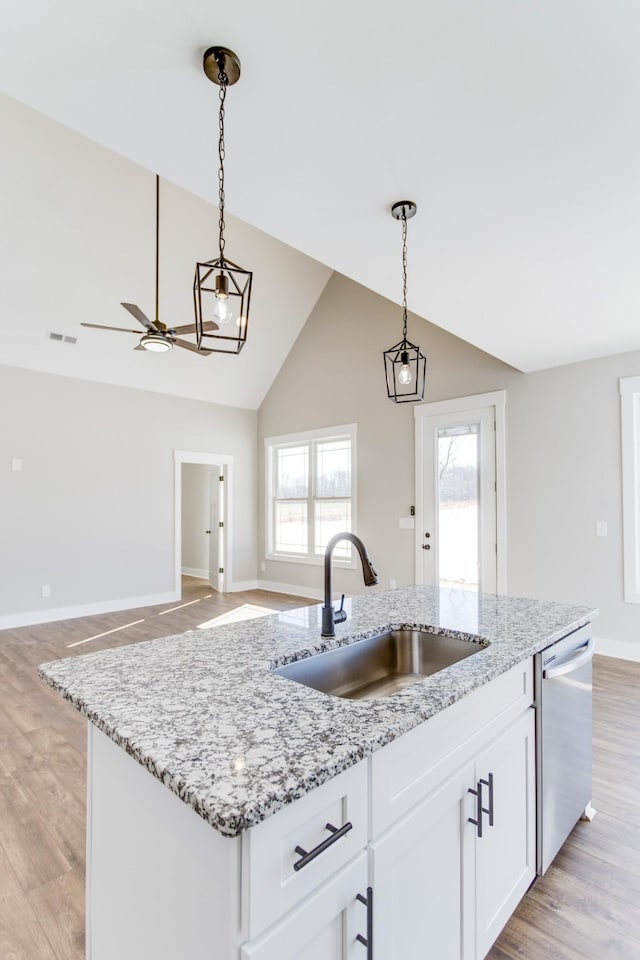 kitchen with sink, hanging light fixtures, dishwasher, a kitchen island with sink, and white cabinets