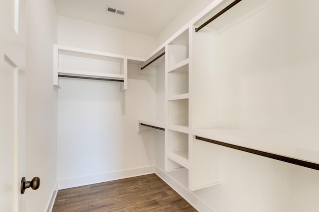 spacious closet featuring dark hardwood / wood-style floors