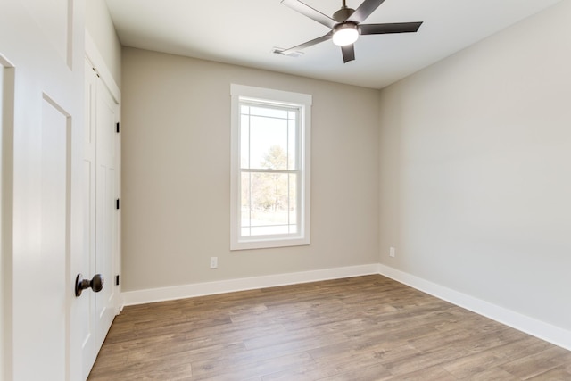 empty room with wood-type flooring and ceiling fan