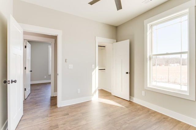 unfurnished bedroom with a closet, ceiling fan, and light wood-type flooring