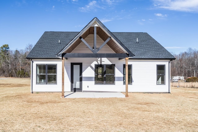 back of property featuring a yard and a patio area