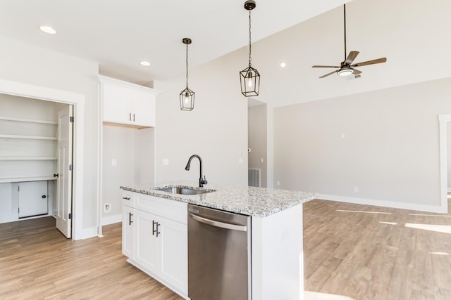 kitchen with white cabinetry, dishwasher, sink, and light stone countertops