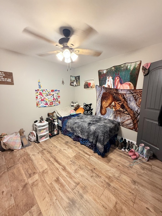 bedroom featuring hardwood / wood-style flooring and ceiling fan