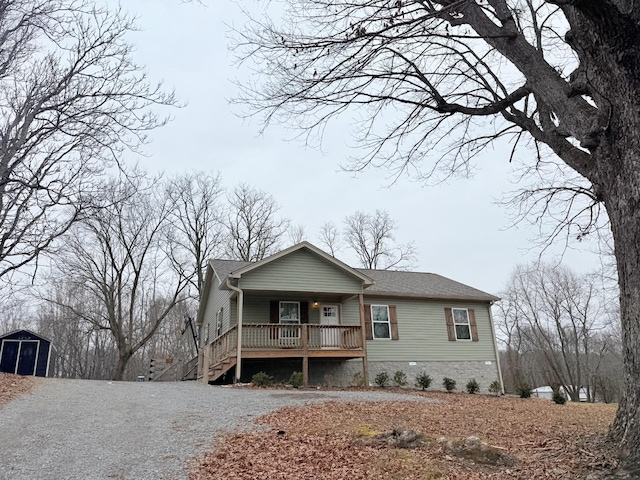 view of front facade featuring a porch and a storage unit