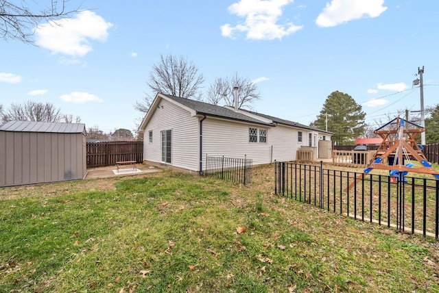 exterior space featuring a shed, a lawn, and a playground