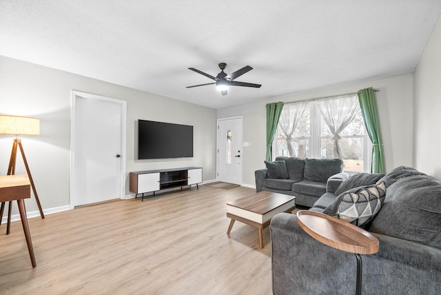 living room with ceiling fan and light wood-type flooring