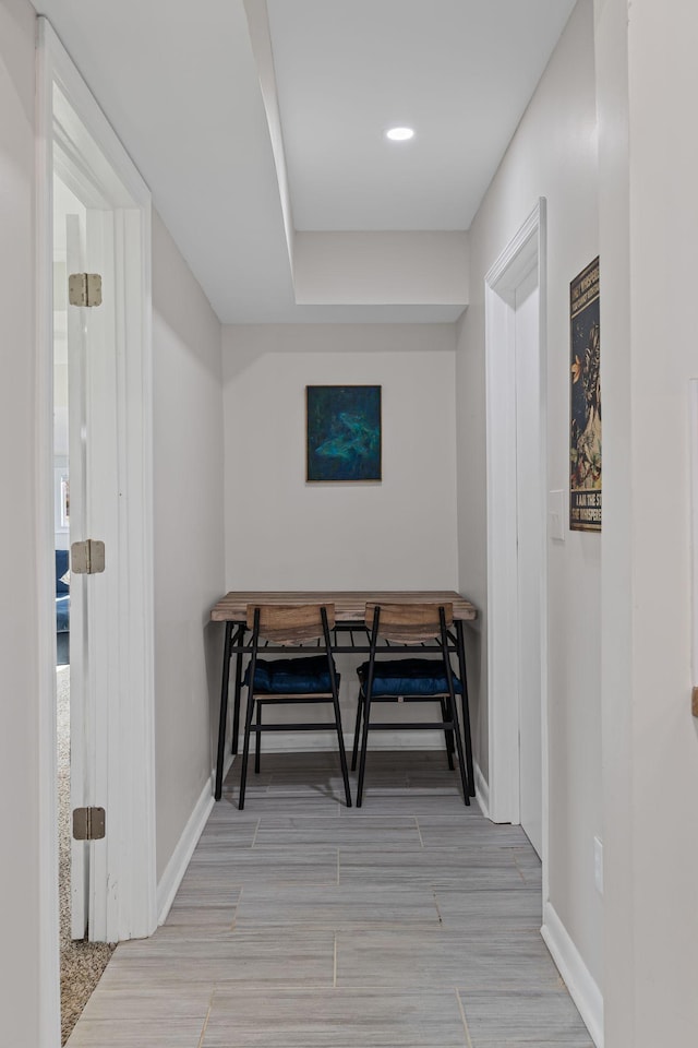 corridor with light hardwood / wood-style floors