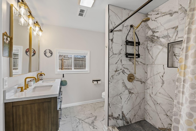 bathroom with vanity, curtained shower, and toilet