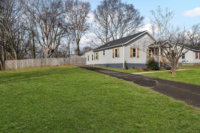 view of side of property with a yard