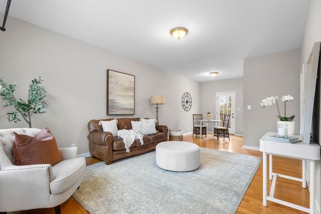 living room featuring light wood-style flooring and baseboards