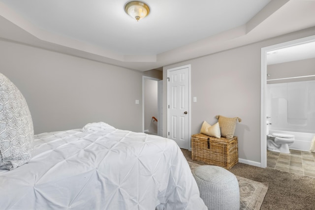 bedroom with carpet, connected bathroom, and baseboards