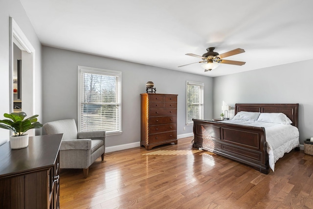 bedroom with ceiling fan and dark hardwood / wood-style flooring