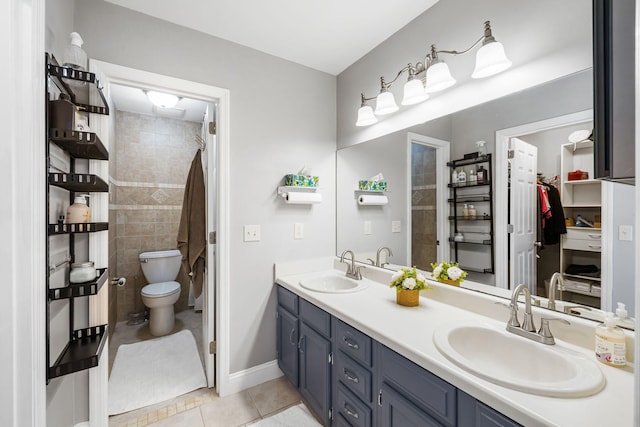 bathroom featuring vanity, tile patterned floors, and toilet