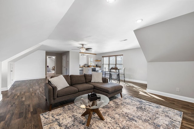 living room featuring ceiling fan, dark hardwood / wood-style flooring, and vaulted ceiling