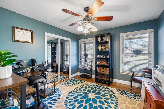 home office featuring plenty of natural light, light hardwood / wood-style floors, and ceiling fan