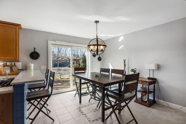 tiled dining space featuring a notable chandelier