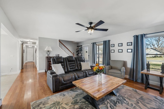 living room featuring ceiling fan, a healthy amount of sunlight, and light hardwood / wood-style flooring