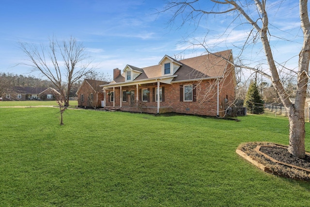 cape cod house with covered porch and a front lawn