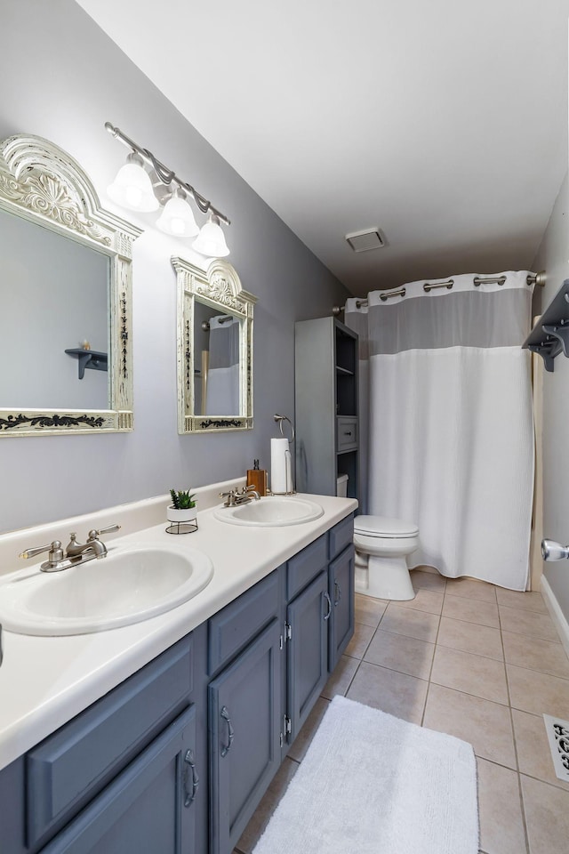 bathroom featuring tile patterned flooring, vanity, and toilet