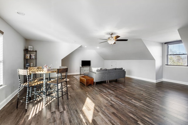 interior space with ceiling fan, lofted ceiling, and dark hardwood / wood-style flooring